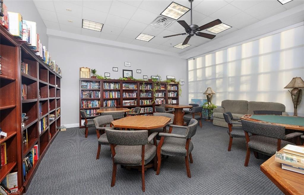 29 High Point Circle East, Unit 308 Naples, FL 34103 - Photo 36 of 39 a view of a livingroom with furniture and a bookshelf