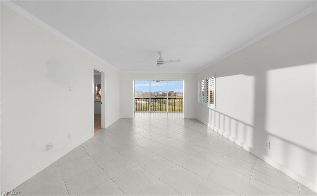 29 High Point Circle East, Unit 308 Naples, FL 34103 - Photo 4 of 39 wooden floor in an empty room with a fireplace