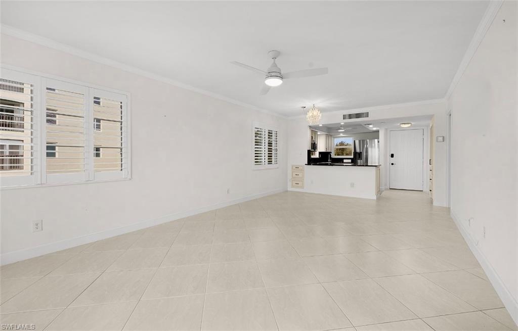 29 High Point Circle East, Unit 308 Naples, FL 34103 - Photo 6 of 39 a view of a kitchen with a sink and a window