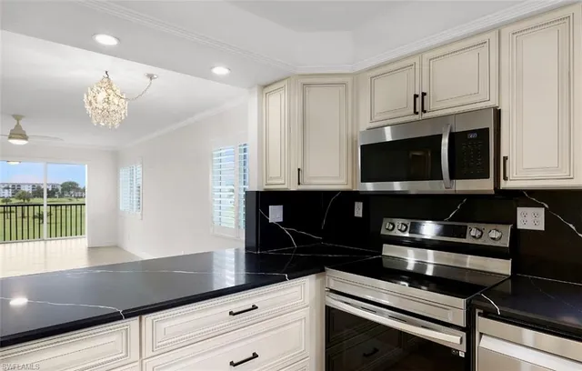 a kitchen with stainless steel appliances a stove microwave and cabinets