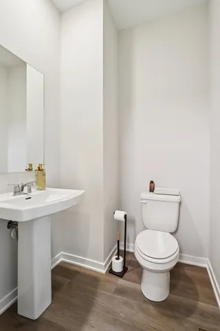 a white toilet sitting next to a bathroom sink