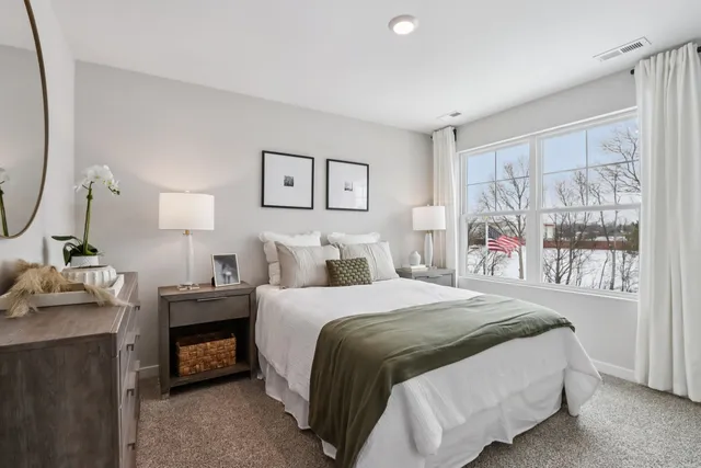 a bedroom with a bed and a mirror