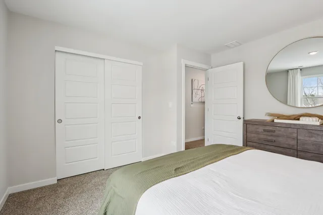 a bedroom with a bed and a dresser