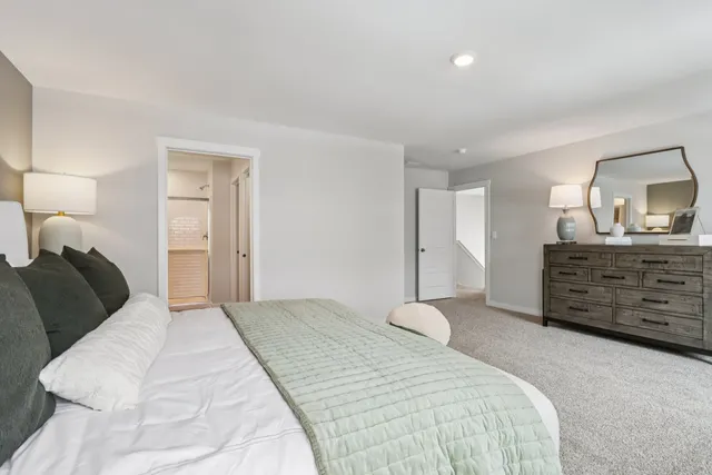 a bedroom with a bed and a dresser