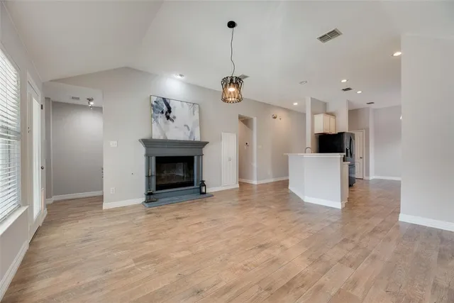 a view of a kitchen with a sink and a fireplace