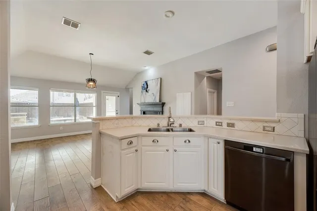 a spacious bathroom with a double vanity sink a mirror and a bathtub