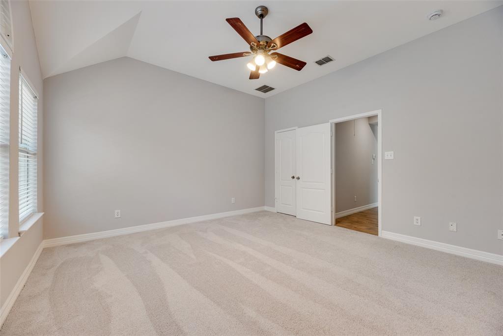 1430 Silver Spur Drive Allen, TX 75002 - Photo 19 of 34 an empty room with ceiling fan and window