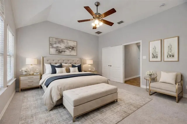 a spacious bedroom with a bed and a couch