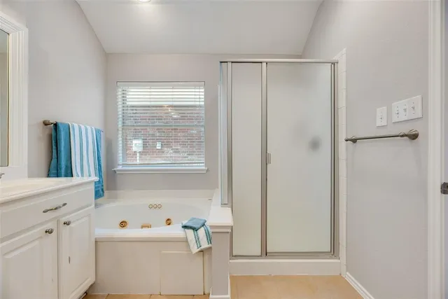 a bathroom with a window a sink and dryer