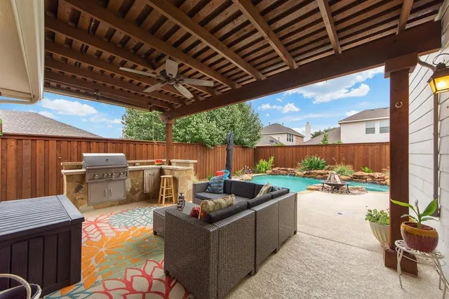 a view of a patio with a table and chairs