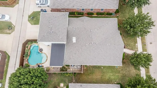an aerial view of a house with outdoor space
