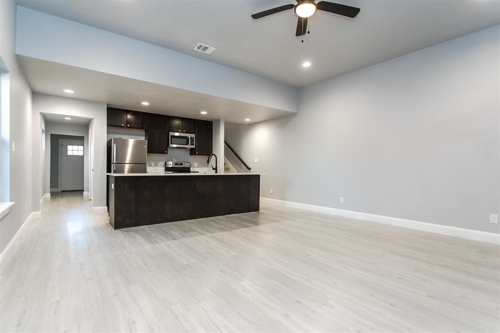 415 West Elm Street, Unit 415 Denison, TX 75020 - Photo 5 of 17 a view of kitchen and kitchen with chandelier fan