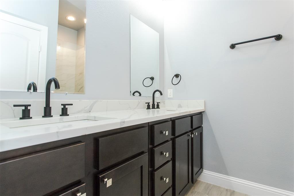 415 West Elm Street, Unit 415 Denison, TX 75020 - Photo 8 of 17 a bathroom with a double vanity sink and a mirror