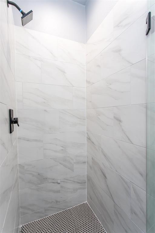 415 West Elm Street, Unit 415 Denison, TX 75020 - Photo 9 of 17 a bathroom with a shower