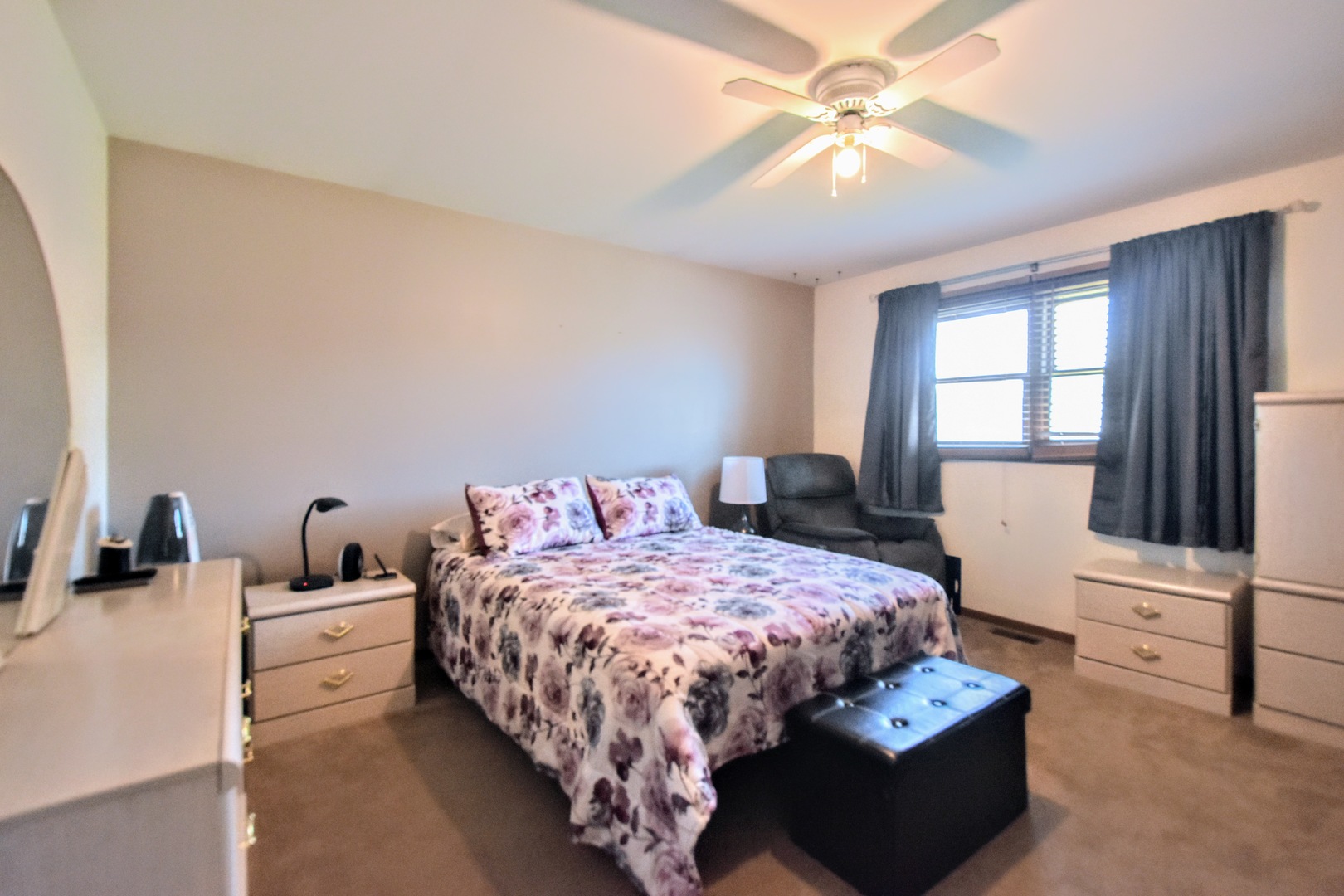 4002 Ridge Road Zion, IL 60099 - Photo 12 of 26 a bedroom with a bed and a chandelier