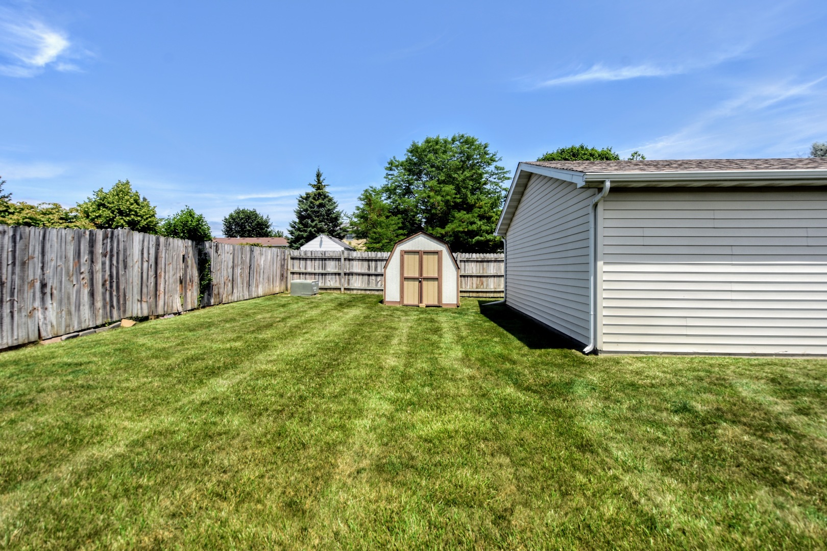4002 Ridge Road Zion, IL 60099 - Photo 23 of 26 a view of a backyard with table and chairs and wooden fence