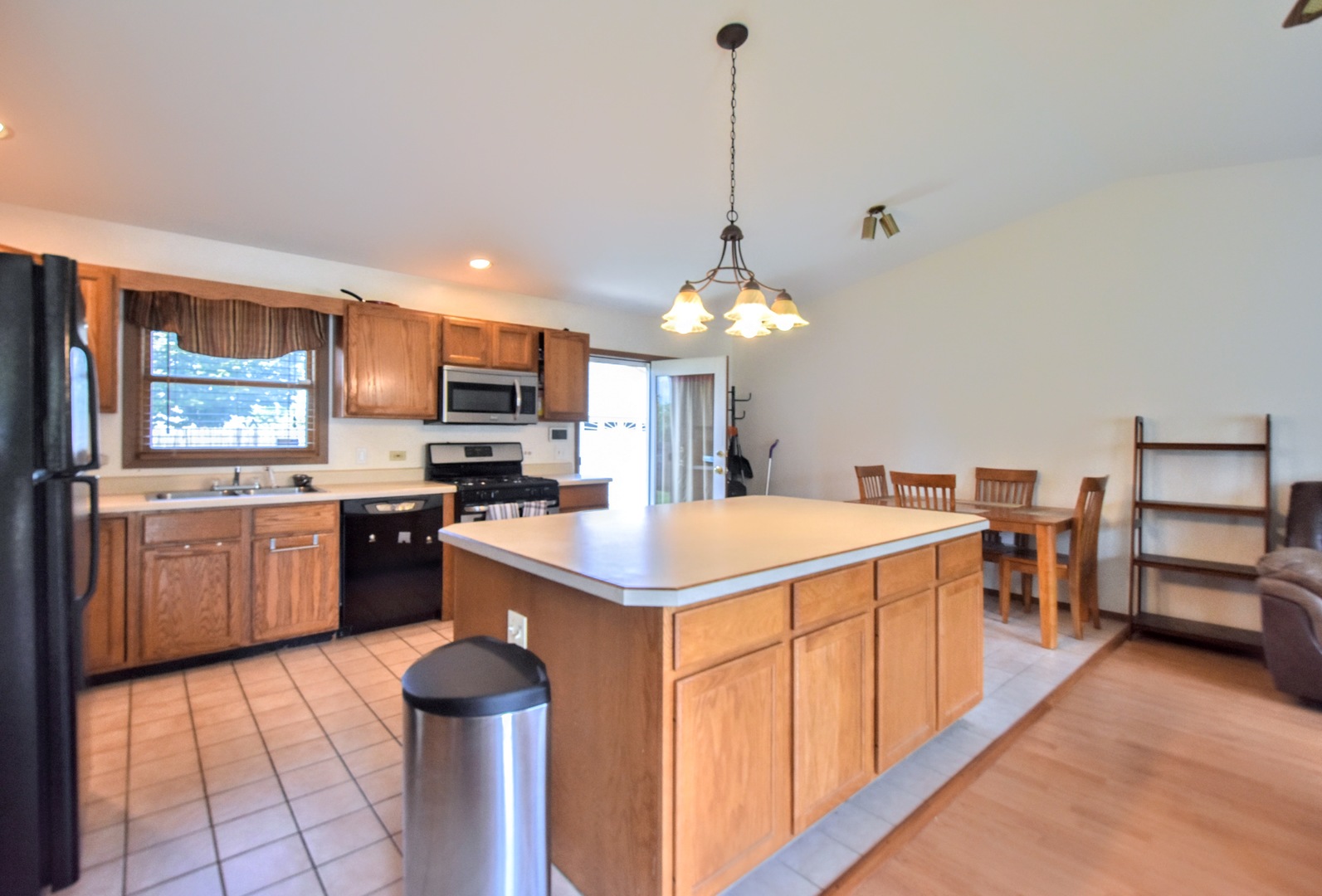 4002 Ridge Road Zion, IL 60099 - Photo 9 of 26 a kitchen with a sink refrigerator and microwave