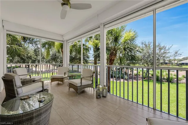 a living room with furniture and a floor to ceiling window