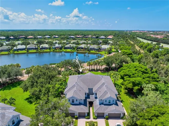an aerial view of a house with a lake view