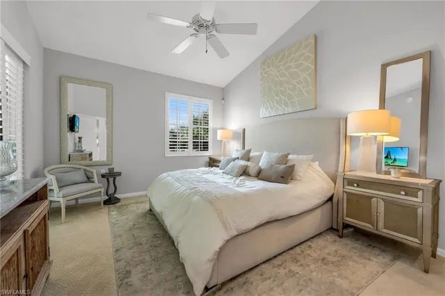 a bedroom with a bed and a dresser with mirror