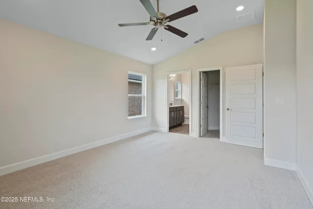an empty room with a ceiling fan and a window