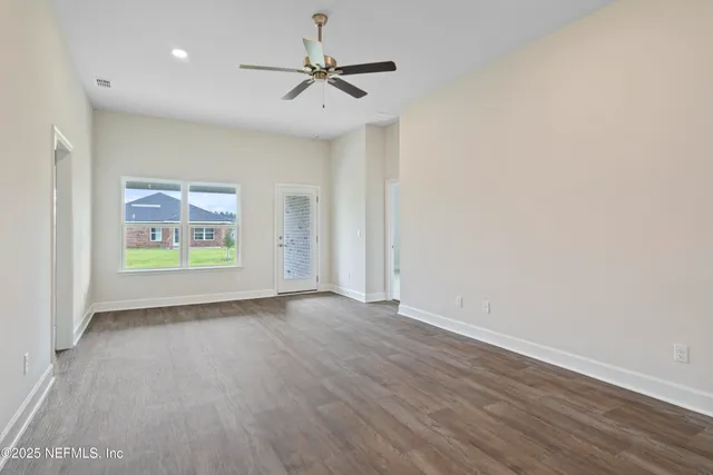 wooden floor in an empty room with a window