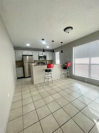 a kitchen with stainless steel appliances a refrigerator and a stove top oven