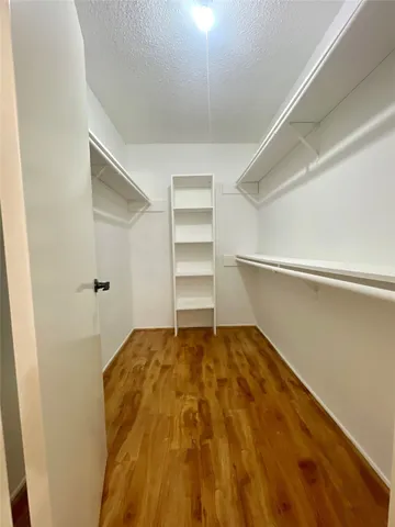 a view of a room with a wooden floor