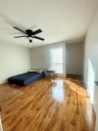 a view of a room with wooden floor and staircase