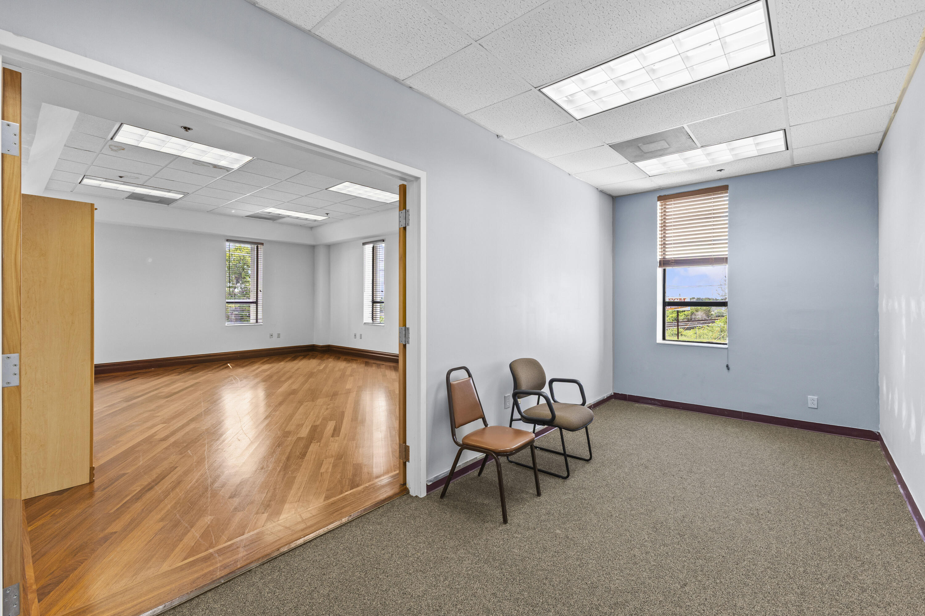 1500 High Ridge Road Boynton Beach, FL 33426 - Photo 18 of 35 a view of an empty room with wooden floor and a window