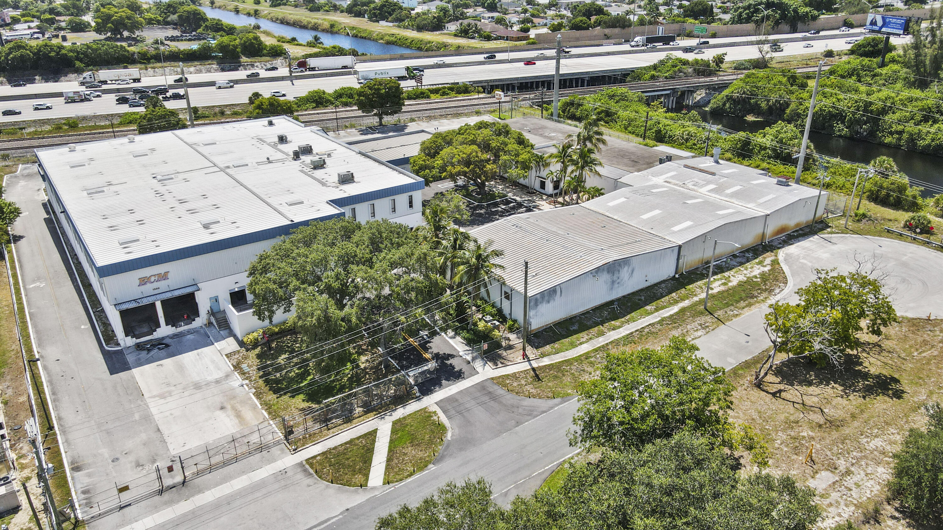 1500 High Ridge Road Boynton Beach, FL 33426 - Photo 4 of 35 an aerial view of a house with large trees and a yard