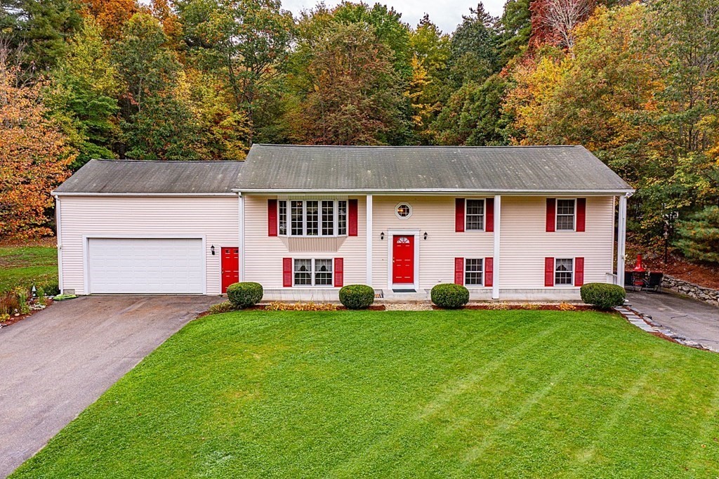 a front view of house with yard and green space