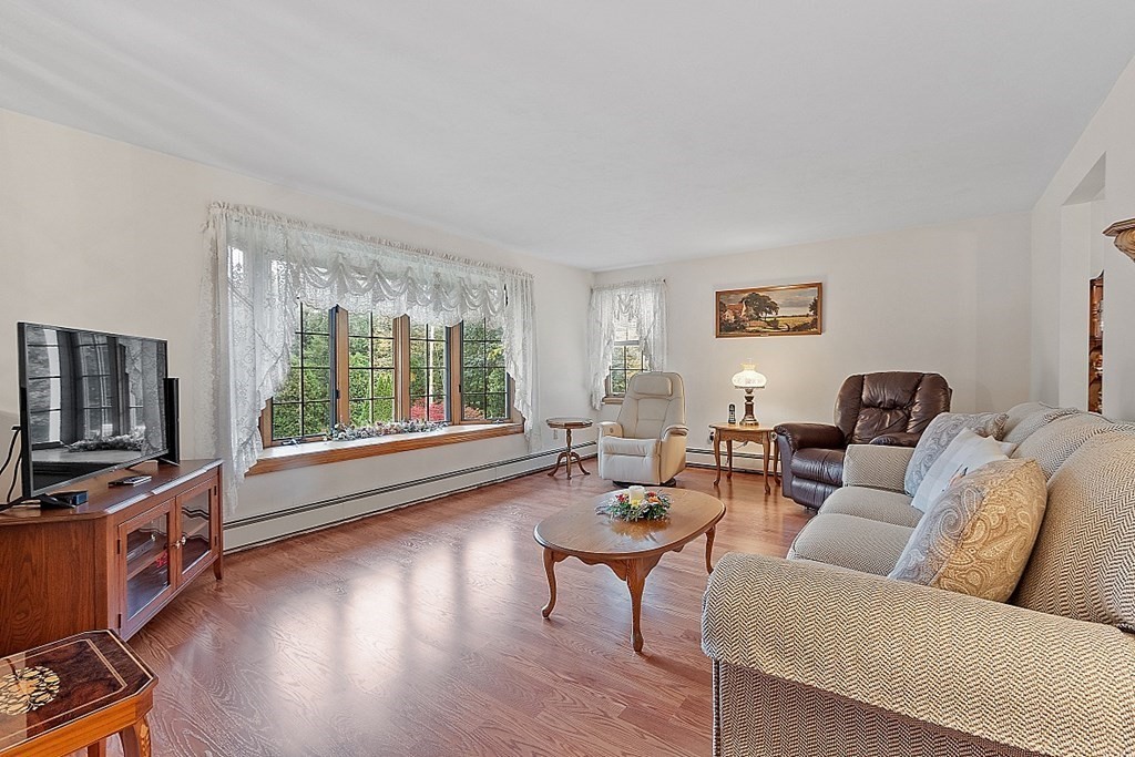252 Great Road Shirley, MA 01464 - Photo 13 of 42 a living room with furniture a flat screen tv and a large window