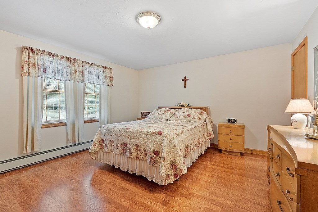 252 Great Road Shirley, MA 01464 - Photo 8 of 42 a bedroom with a bed and wooden floor