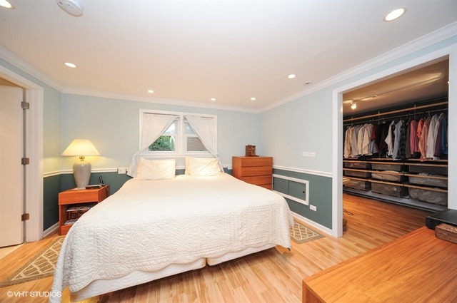 2463 Highmoor Road Highland Park, IL 60035 - Photo 7 of 15 a large bedroom with a bed and wooden floor