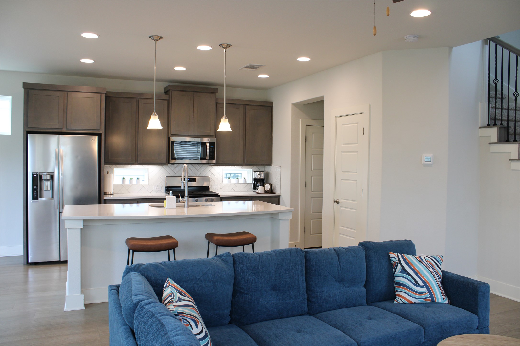 1007 Harwell Loop Kyle, TX 78640 - Photo 40 of 40 a living room with stainless steel appliances kitchen island furniture and a view of kitchen