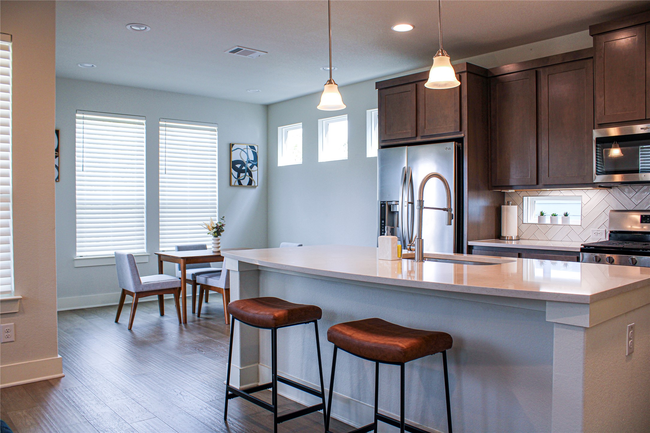 1007 Harwell Loop Kyle, TX 78640 - Photo 20 of 40 a kitchen with stainless steel appliances a dining table chairs and a refrigerator