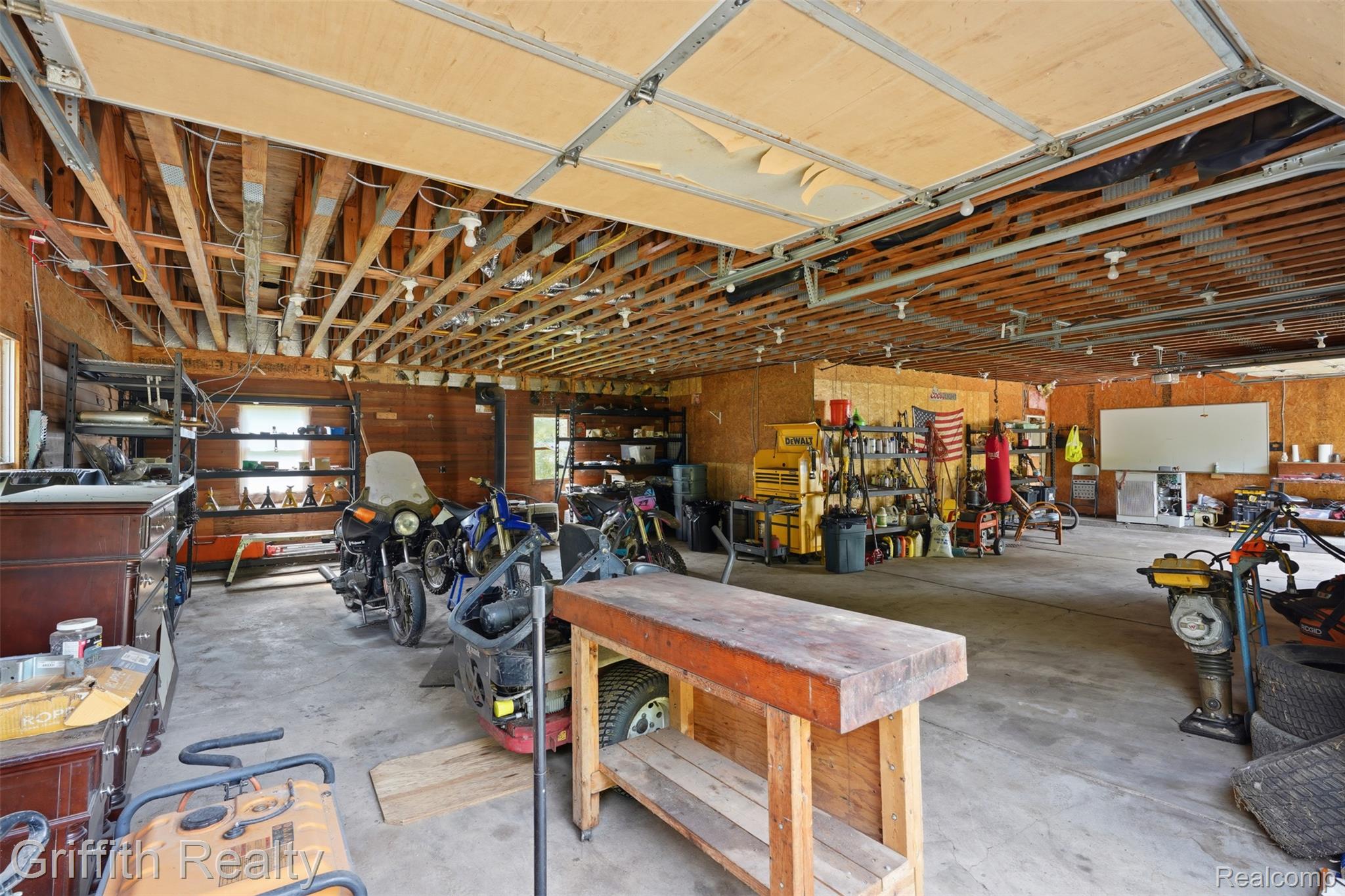 12300 Holtforth Road Fenton, MI 48430 - Photo 19 of 45 Expansive interior space with exposed ceiling joists and concrete flooring