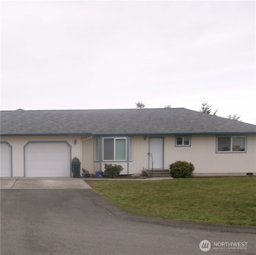 60 Windsor Court Sequim, WA 98382 - Photo 1 of 1 a front view of a house with a garden