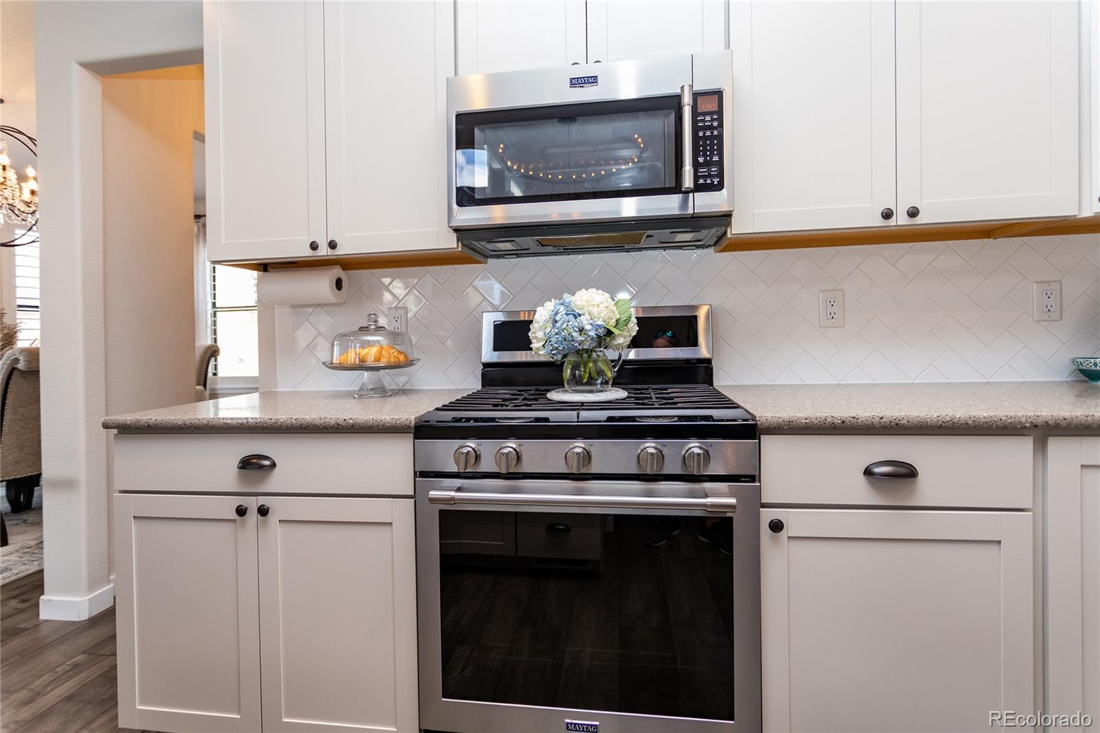 4208 Notch Trail Colorado Springs, CO 80924 - Photo 17 of 40 a kitchen with a stove and a microwave