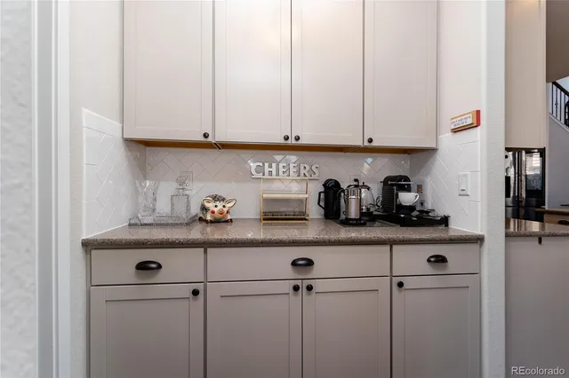 a room with a fridge and shelves
