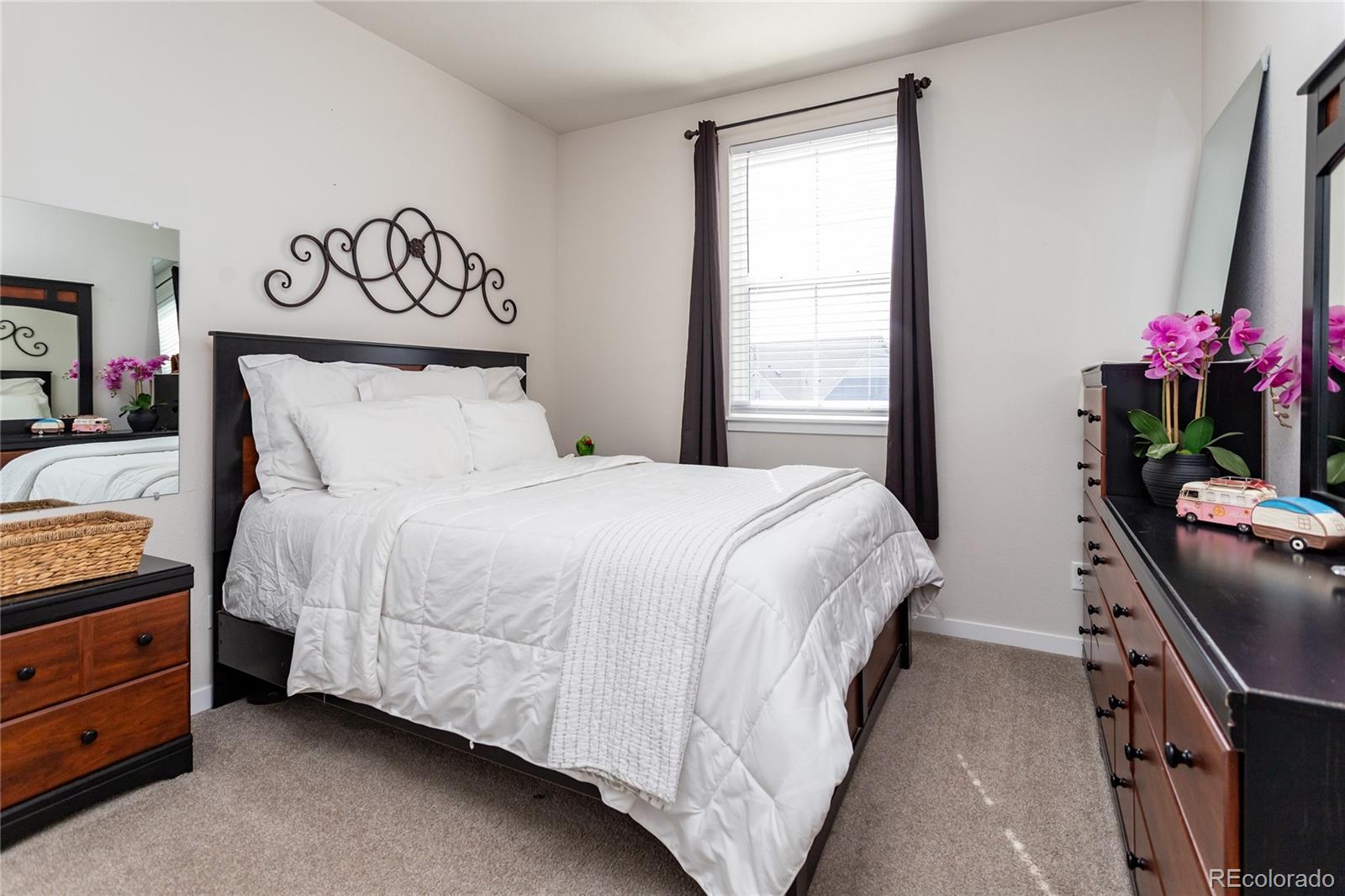 4208 Notch Trail Colorado Springs, CO 80924 - Photo 30 of 40 a bedroom with a bed and a potted plant