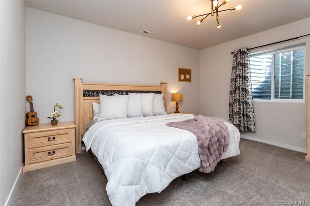 a bedroom with a bed and a dresser