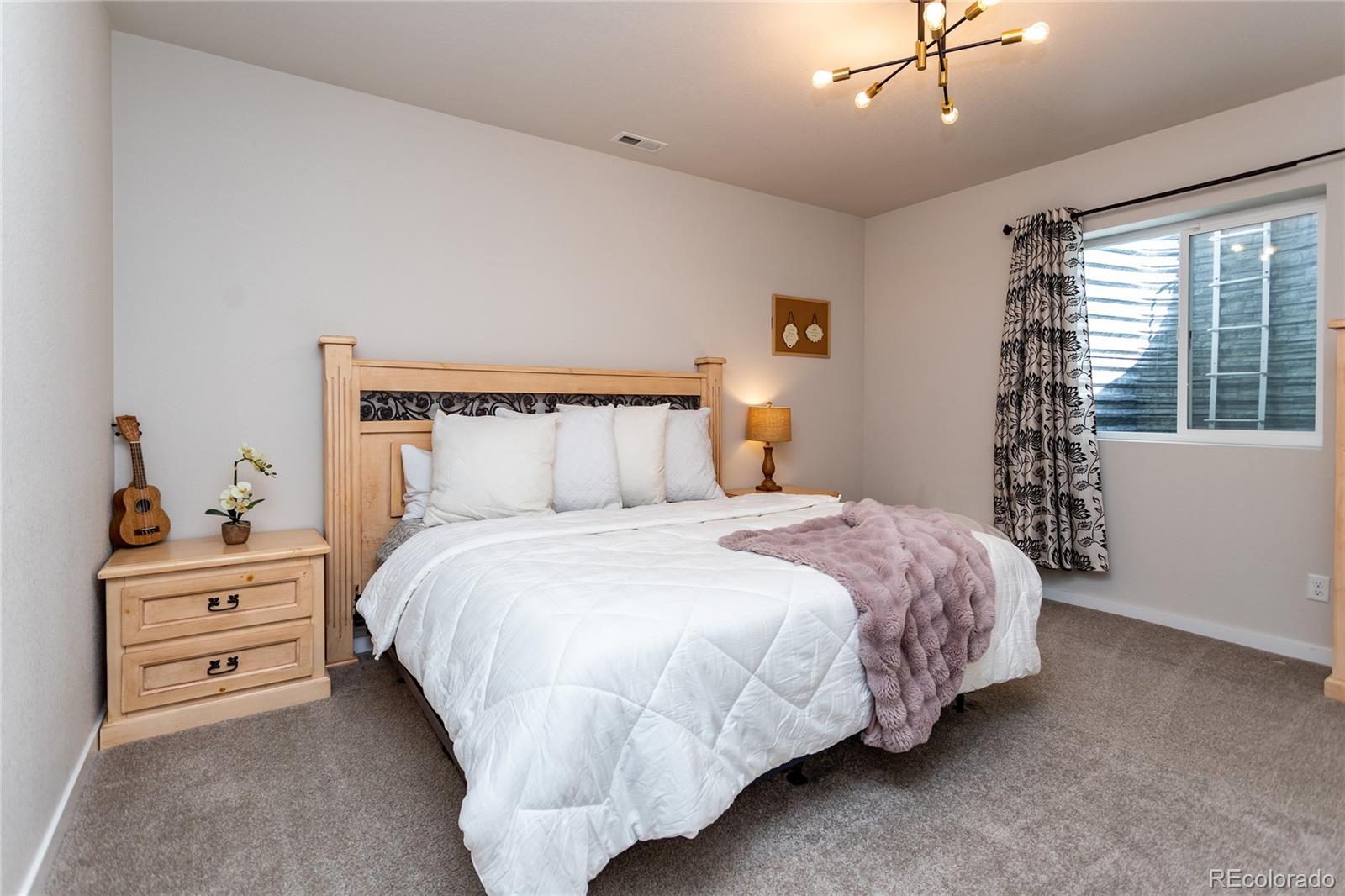 4208 Notch Trail Colorado Springs, CO 80924 - Photo 33 of 40 a bedroom with a bed and ceiling fan