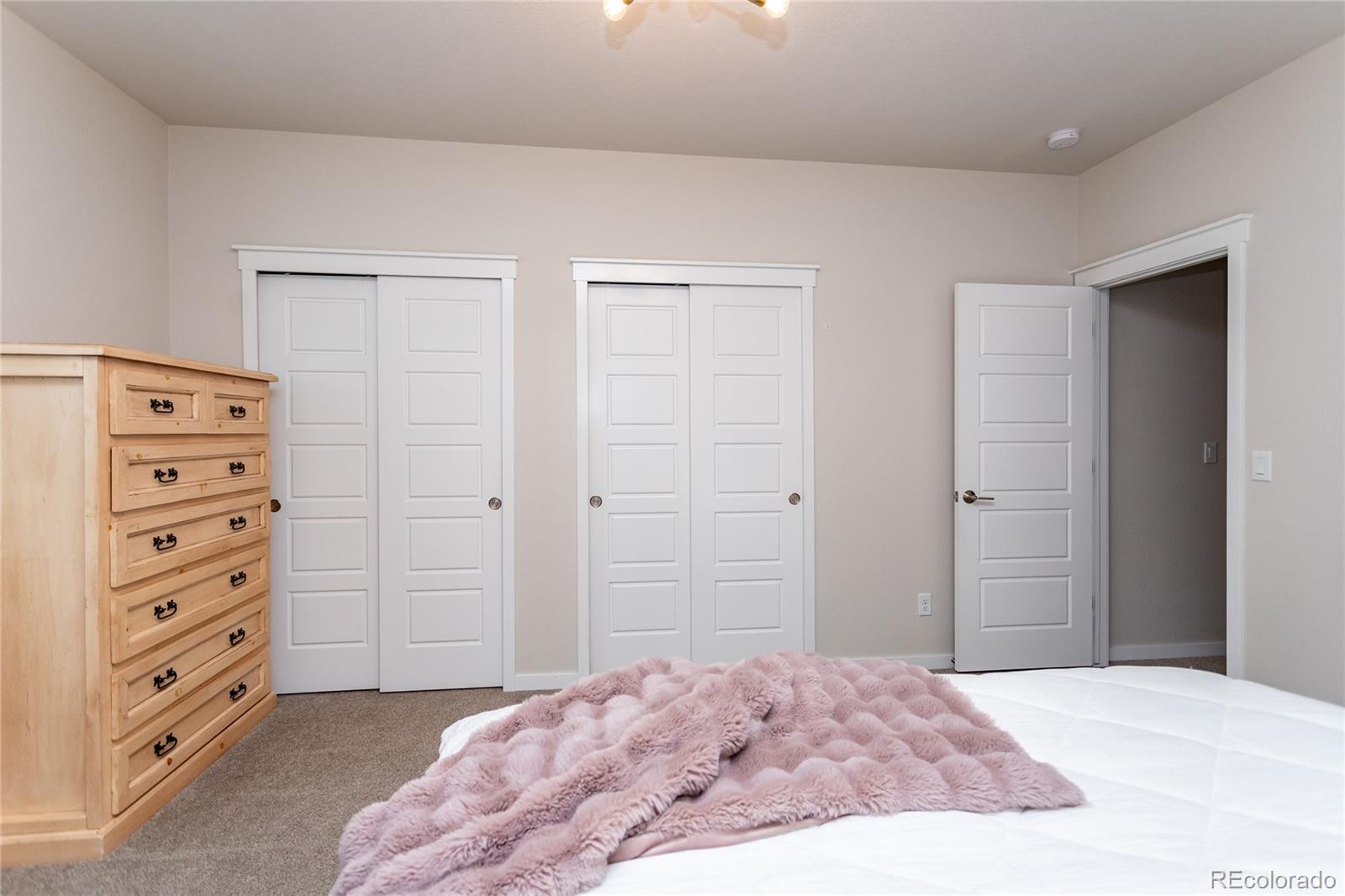 4208 Notch Trail Colorado Springs, CO 80924 - Photo 34 of 40 a bedroom with a bed and a dresser