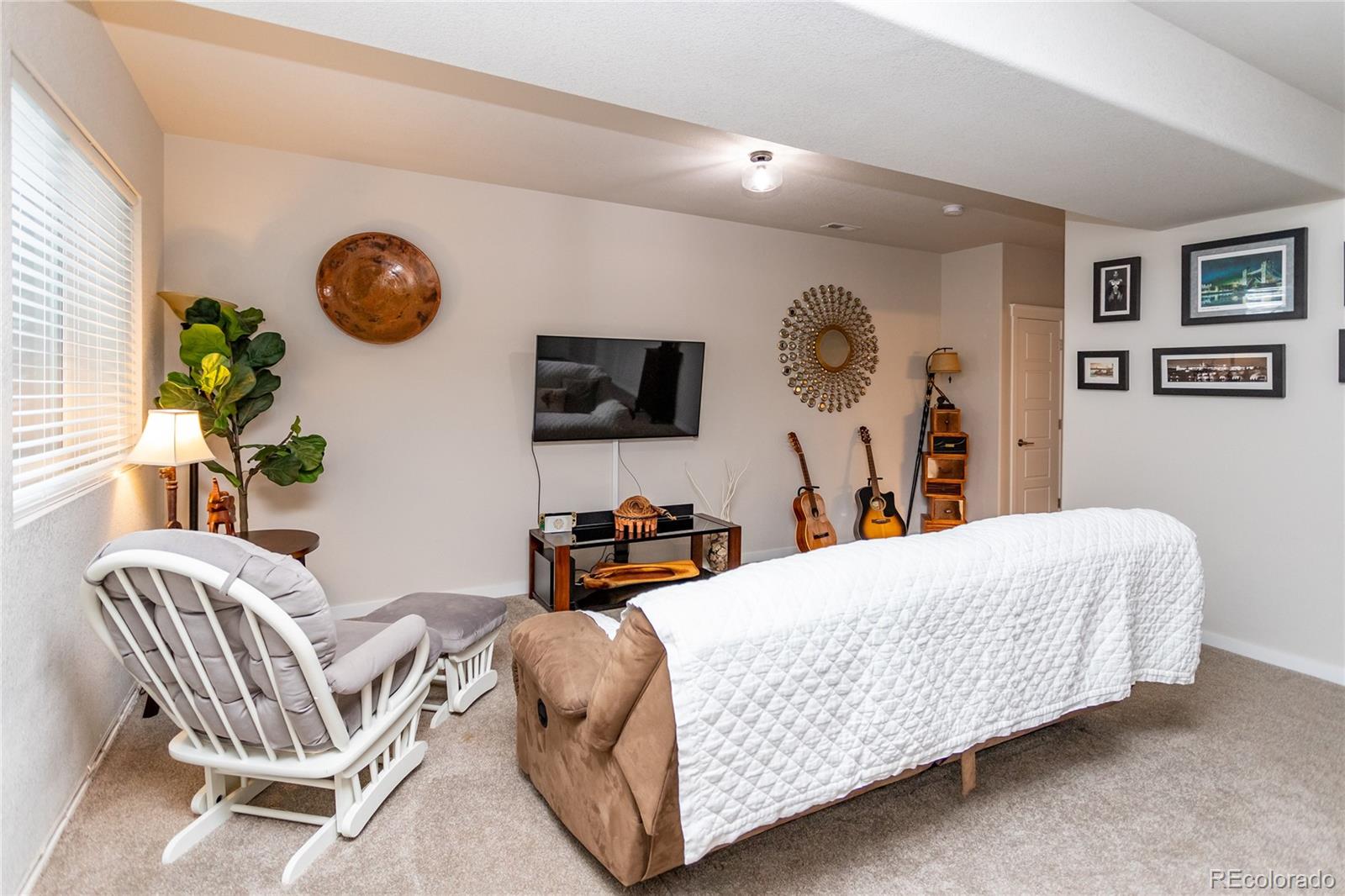 4208 Notch Trail Colorado Springs, CO 80924 - Photo 35 of 40 a living room with a couch and a chandelier