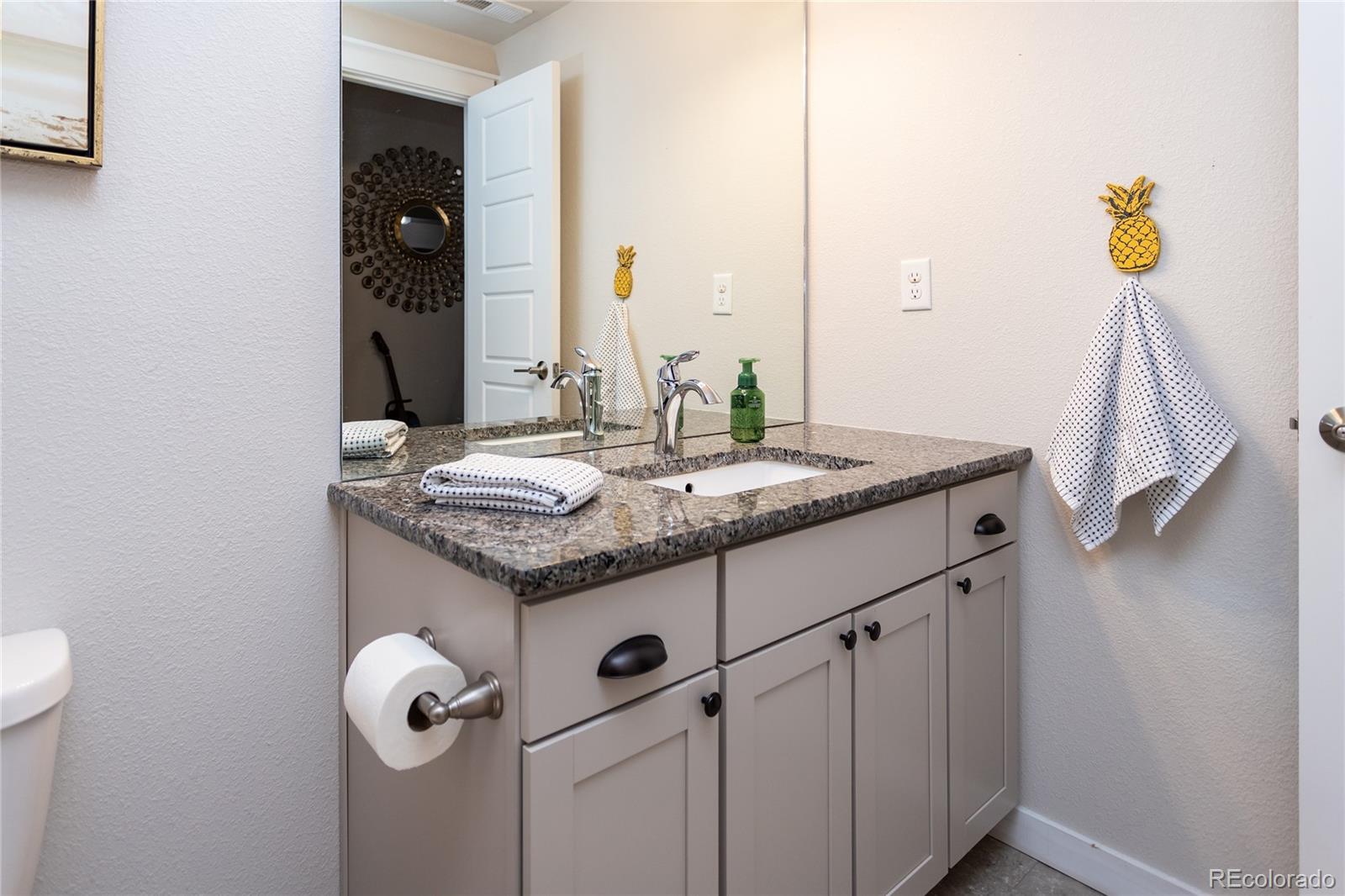 4208 Notch Trail Colorado Springs, CO 80924 - Photo 37 of 40 a bathroom with a granite countertop sink and a mirror