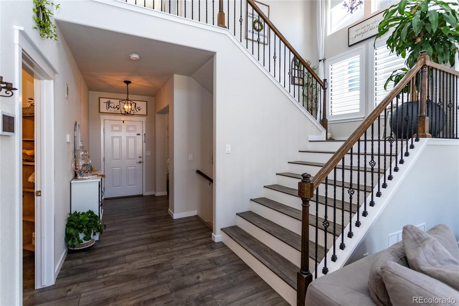 4208 Notch Trail Colorado Springs, CO 80924 - Photo 5 of 40 a view of entryway with wooden floor and stairs