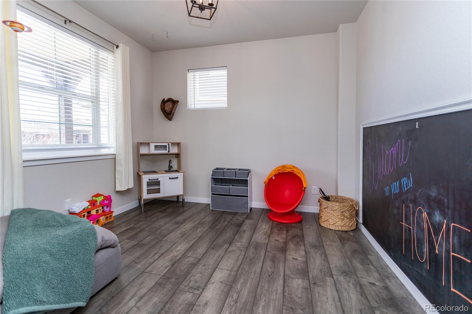 4208 Notch Trail Colorado Springs, CO 80924 - Photo 7 of 40 a living room with furniture and wooden floor