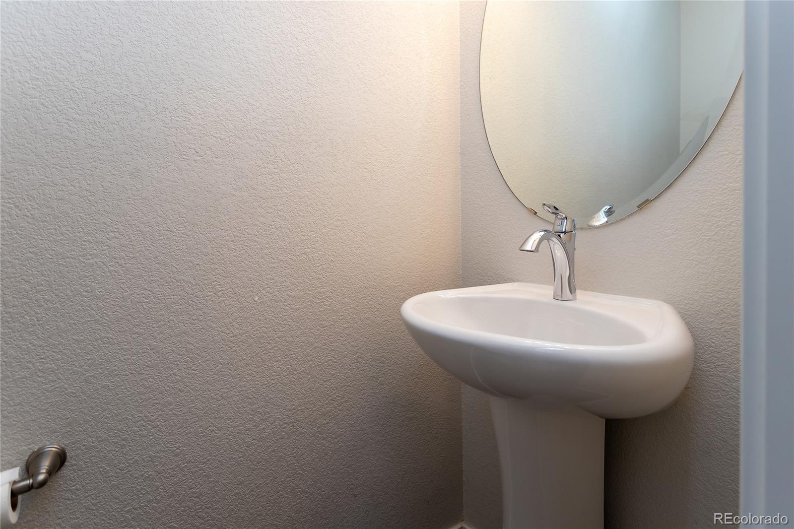 4208 Notch Trail Colorado Springs, CO 80924 - Photo 8 of 40 a bathroom with a sink a mirror and vanity
